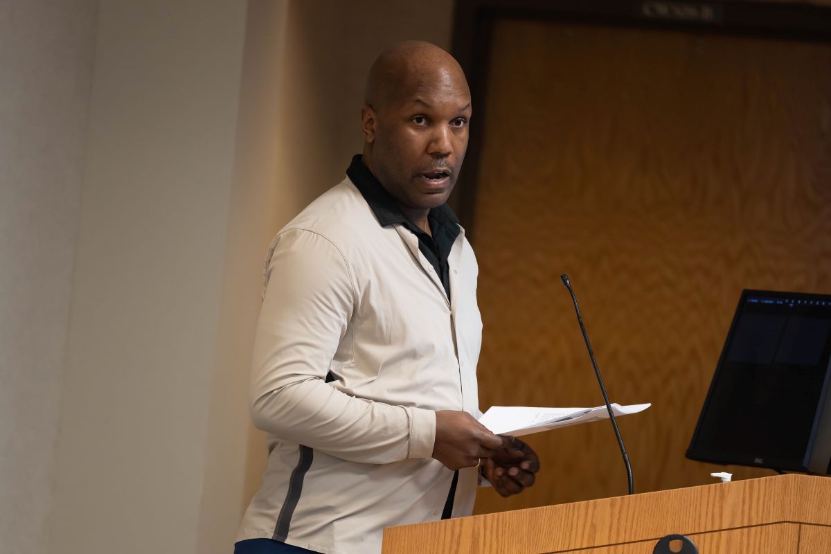 Male presenter standing at the podium at the 2023 SOPH Research Day